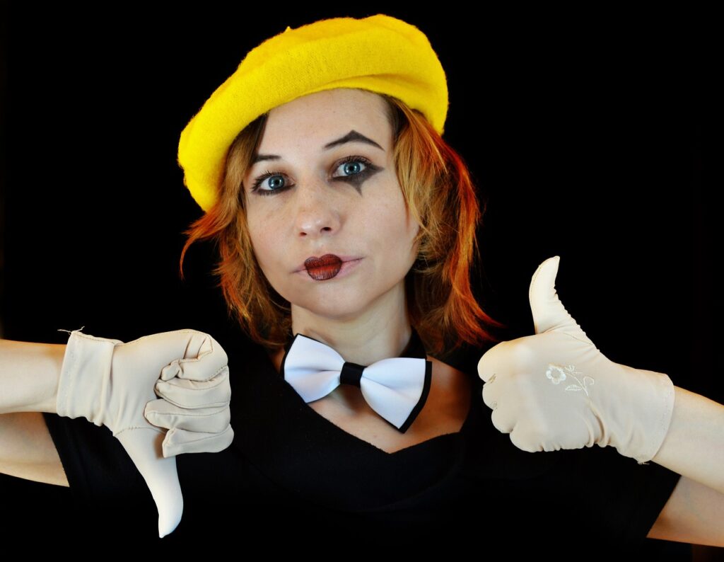 Person with a yellow beret and contrasting makeup giving a thumbs up and a thumbs down gesture | Italian Digital Nomad Visa